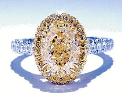 GIA Certified Fancy Yellow Oval Shape with Fancy with Halo & Side Diamonds.